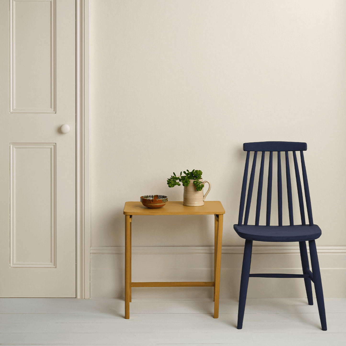Original - Annie Sloan Satin Paint used on a wall with a blue chair and wooden table.
