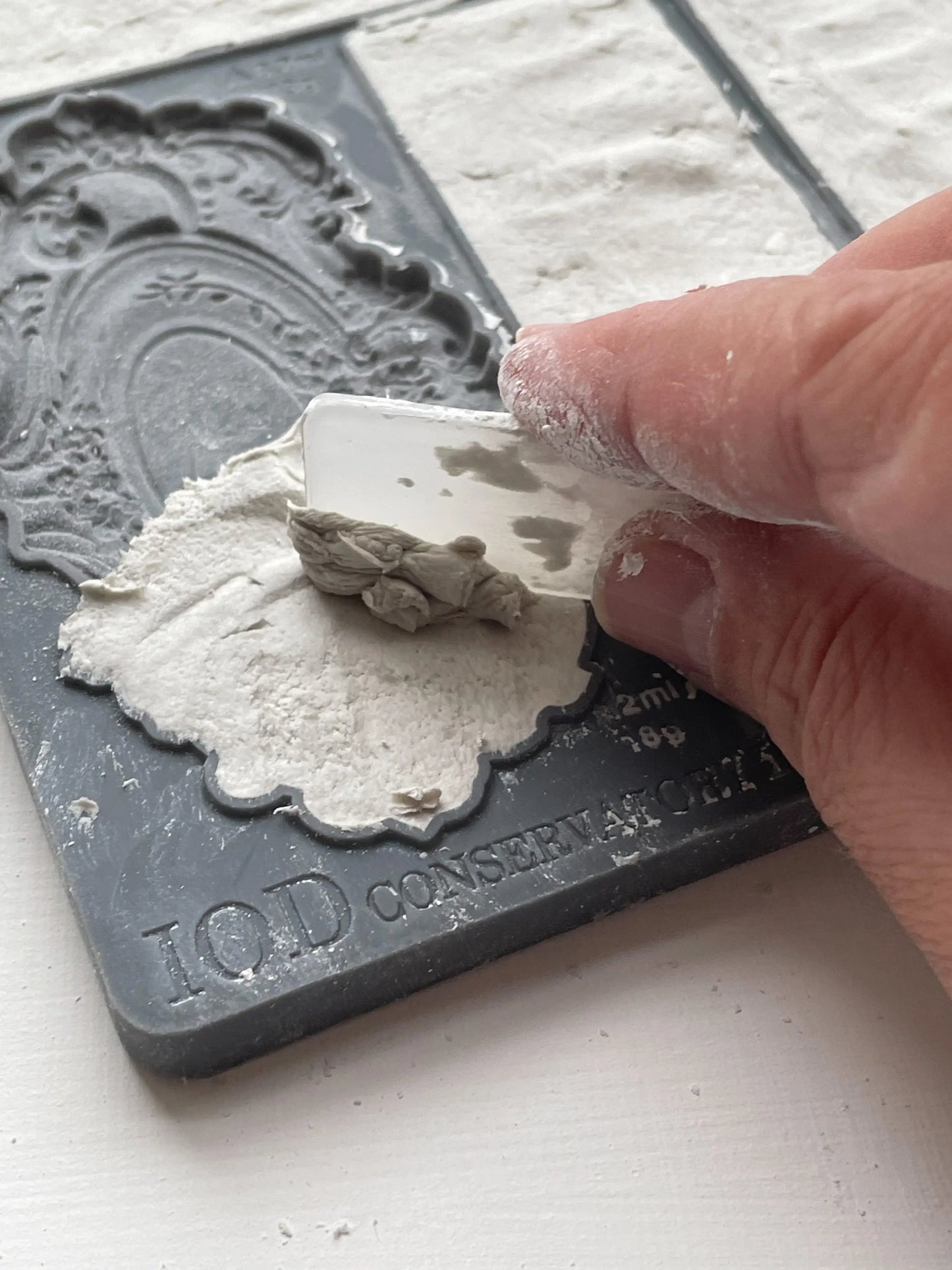 IOD Conservatory Labels Decor Mould being used to create vintage label designs with clay.
