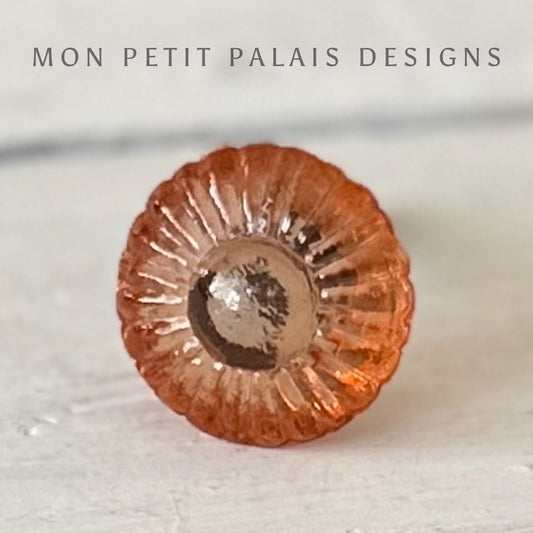 A single round, orange glass knob with a textured surface designed for use as a door handle or cabinet knob.