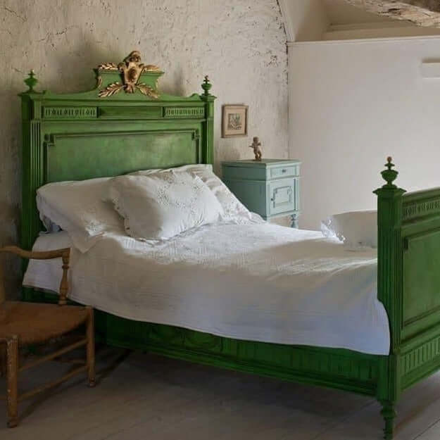 Antique wooden bed frame upcyled in Annie Sloan Antibes Green Chalk Paint and dark wax for a fresh country bedroom style.