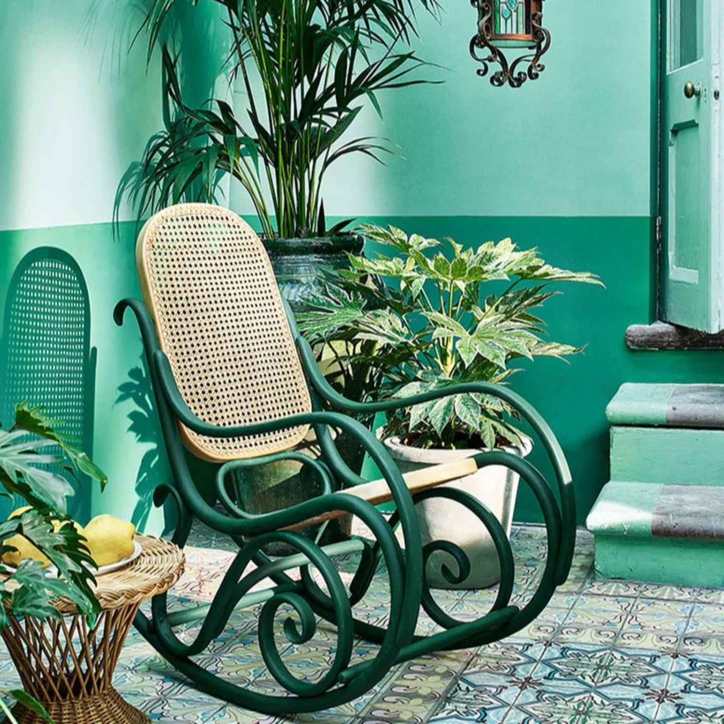 Amsterdam Green - Annie Sloan Chalk Paint used on a vintage rocking chair in a vibrant green space with plants.