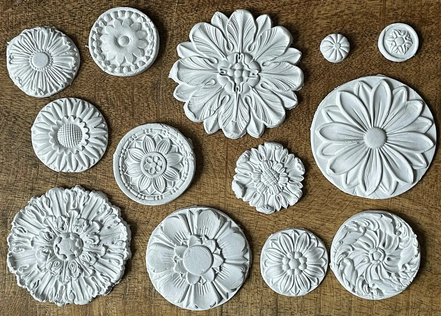IOD Rosettes Decor Mould featuring 13 detailed floral medallions in varying sizes for crafts and furniture.