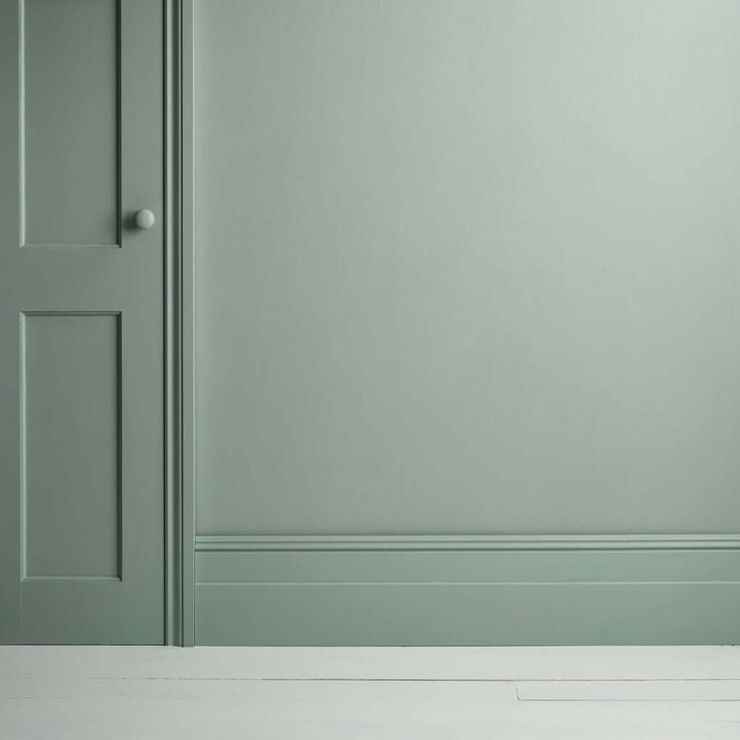 Pemberley Blue - Annie Sloan Satin Paint applied to a wall and door, showcasing a refined pastel blue finish.