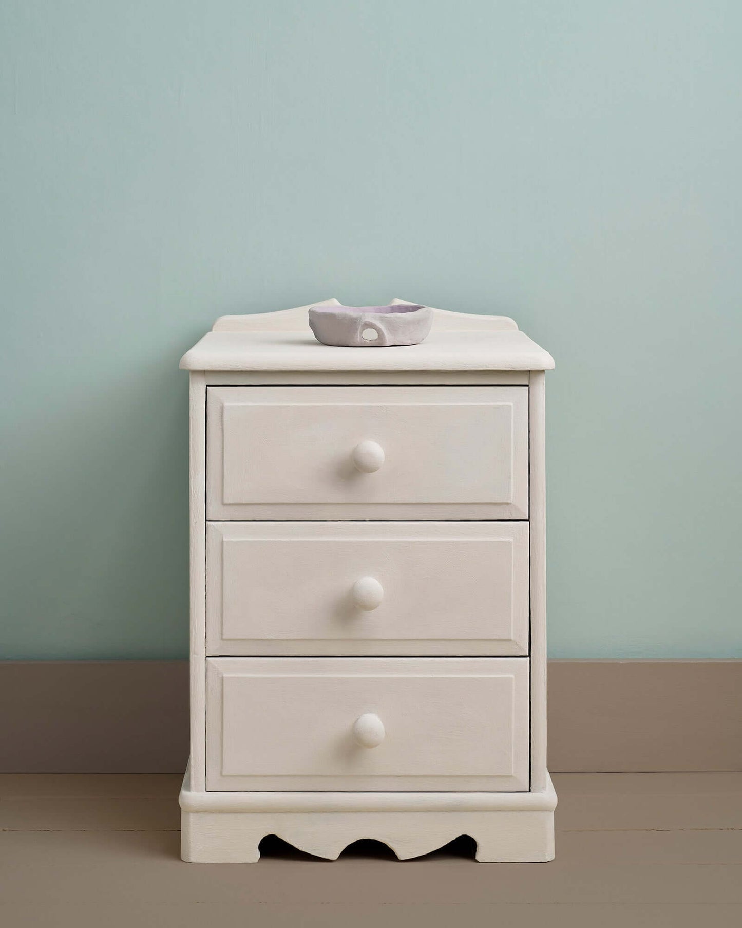 Furniture painted in Rococo White Chalk Paint by Annie Sloan, set against a soft blue wall.