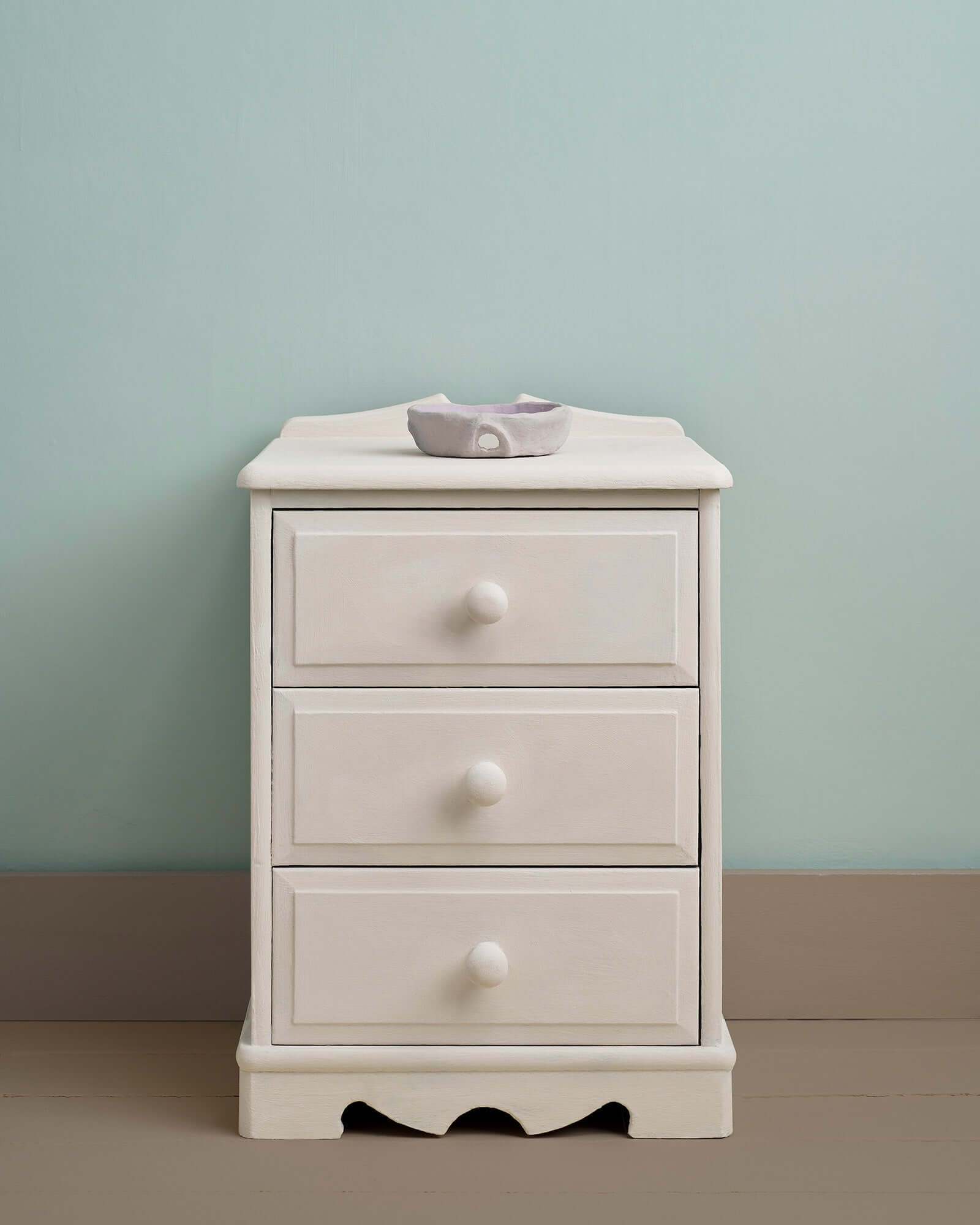 Furniture painted in Rococo White Chalk Paint by Annie Sloan, set against a soft blue wall.
