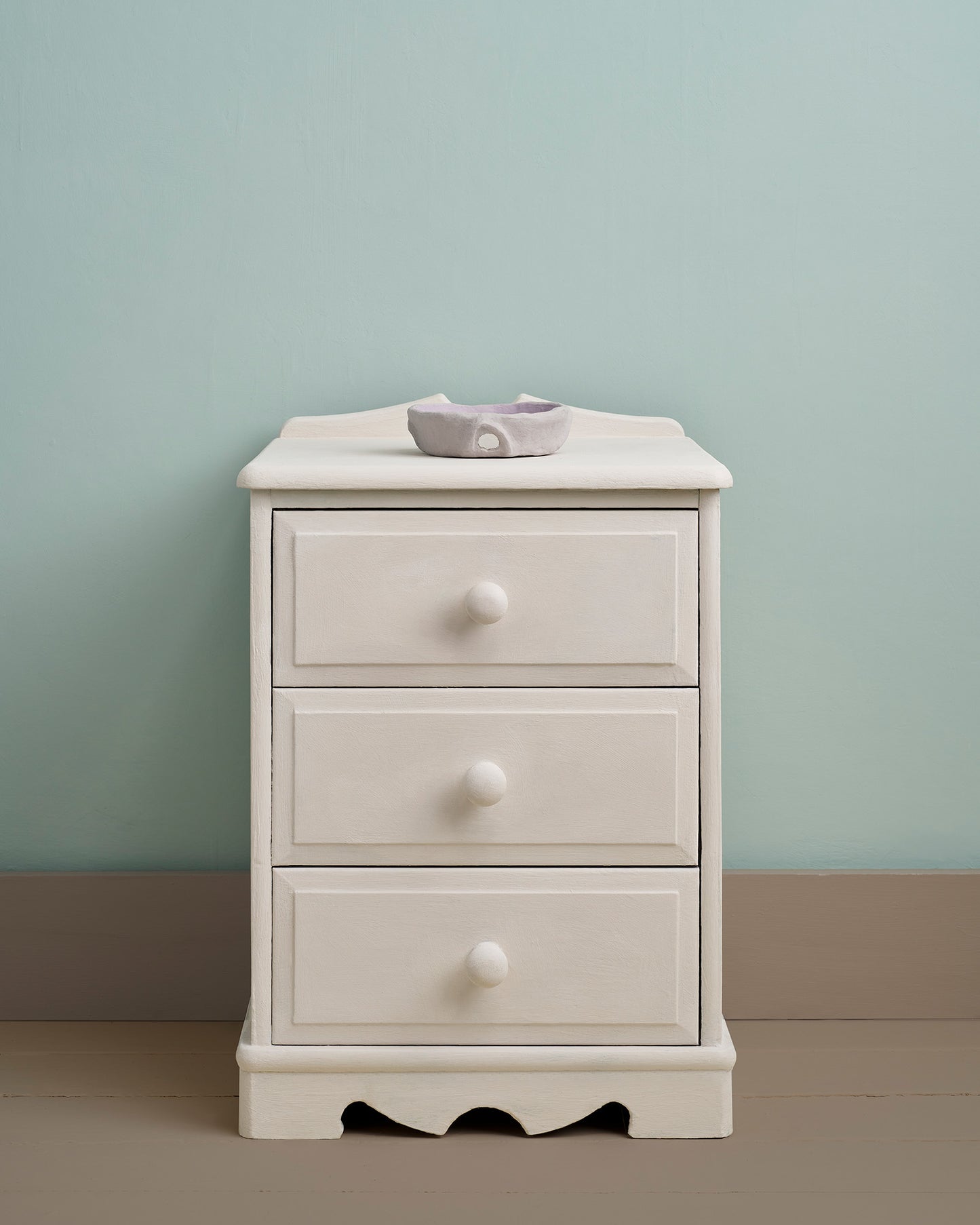Furniture painted in Rococo White Chalk Paint by Annie Sloan, set against a soft blue wall.