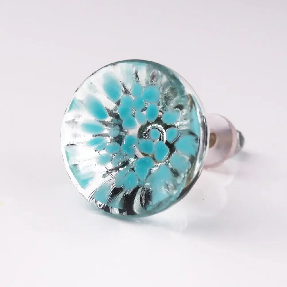 Turquoise floral design on a silver background