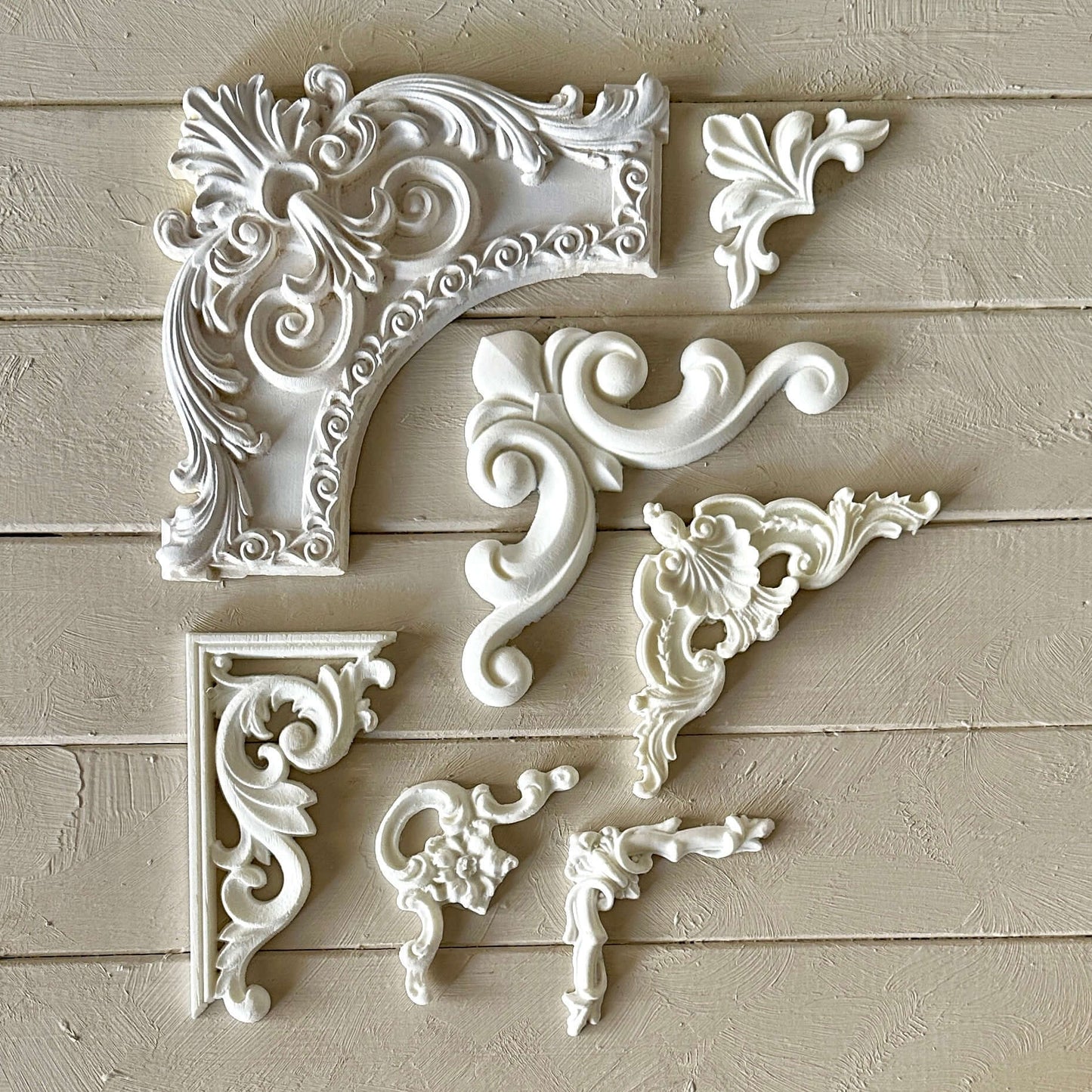 Corner 003 - Resin Applique for Furniture & Crafts decorative white accents arranged on a wooden background.