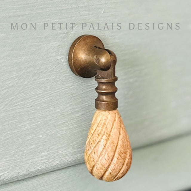 Elodie drop handles with carved wood teardrop and antique brass mount - perfect for French or coastal furniture updates.