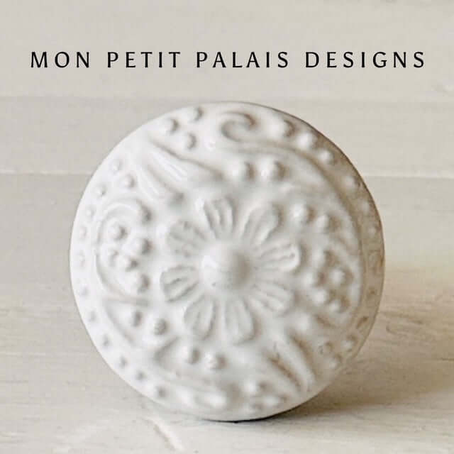 White ceramic knob with floral embossed design, Satin finish, with the text 'MON PETIT PALAIS DESIGNS' above it.