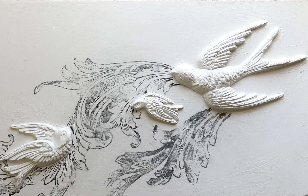 IOD Birdsong Decor Mould showing intricately detailed bird designs in white on a textured background.