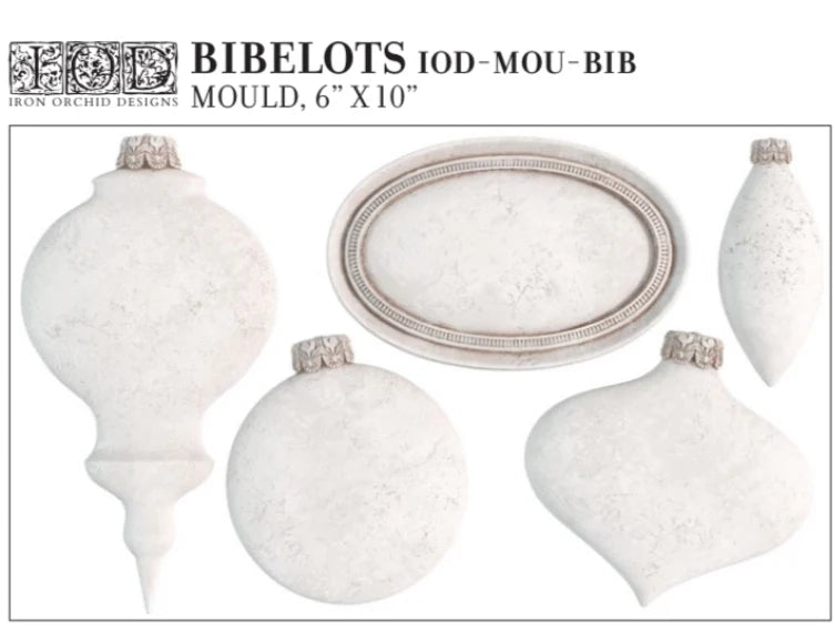 Full product image of the IOD Bibelots Mould, featuring a variety of vintage-inspired ornament shapes and an oval plaque design, with measurements of 6" x 10", ideal for crafting and upcycling.