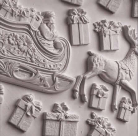 IOD Santa’s Sleigh Decor Mould showcases detailed castings of Santa's sleigh, reindeer, and gift boxes.
