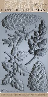 IOD Winter Forage Decor Mould™ showcasing intricate pinecones and foliage designs for seasonal decor.