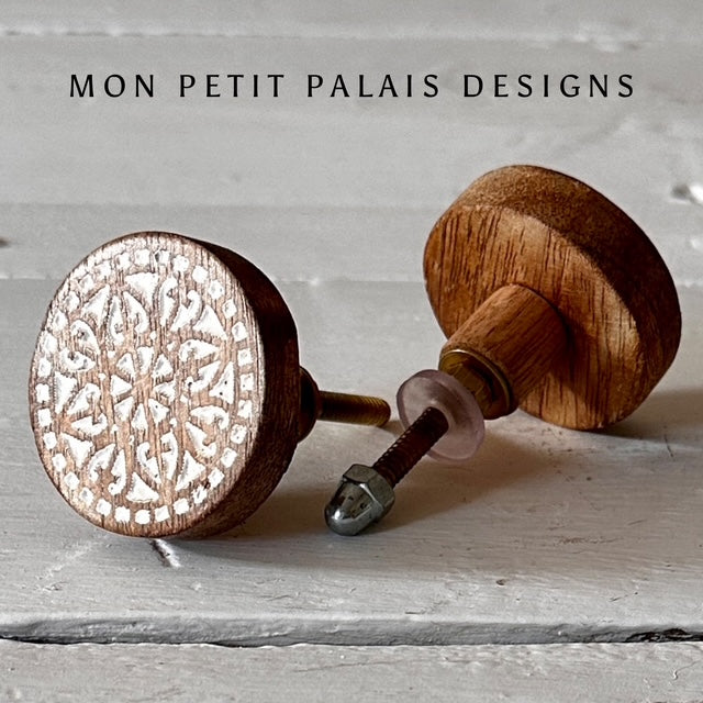 Pair of Marie carved wood knobs showing side and front view - relaxed boho styling with warm wood tones.
