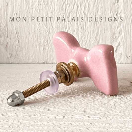 Pink Ceramic Bow Cabinet Knob with chic bow shape and glossy finish, perfect for adding charm to furniture.