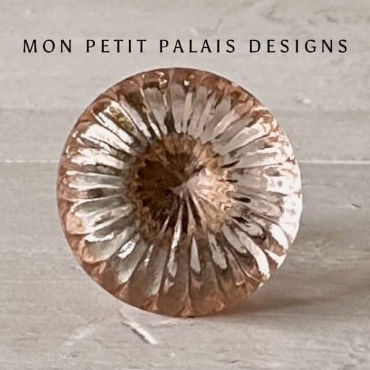 Front view of Rose Quartz Glass Knob, showcasing intricate fluted detailing and light-reflecting facets for an elegant vintage touch.