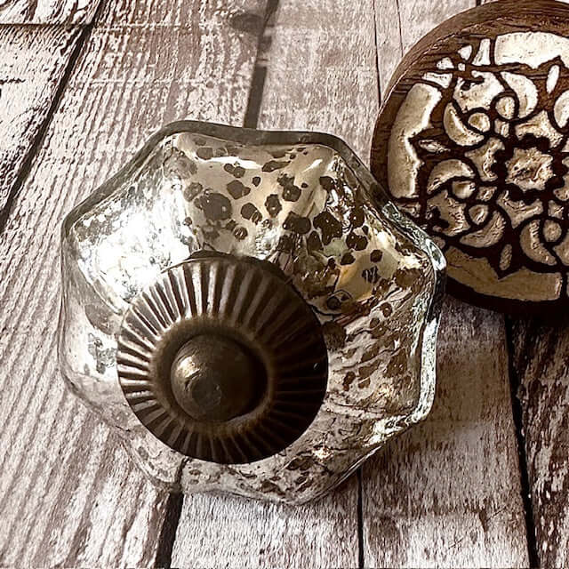 Styled flat lay of mercury glass knob with bronze centre and Zoe carved wood knob - eclectic hardware from Mon Petit Palais Designs for upcycled furniture.