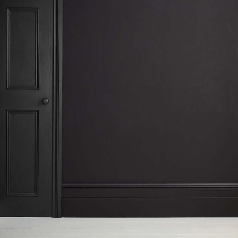 Athenian Black - Annie Sloan Satin Paint on a wall and door, showcasing a glossy pitch-black finish.