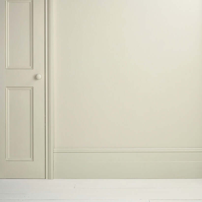 Cotswold Green - Annie Sloan Satin Paint on a wall with a beige door and white trim.