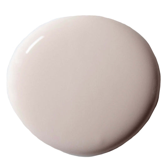 Swatch of Pointe Silk paint from Annie Sloan, showcasing a soft, creamy neutral color in a smooth, round pool.