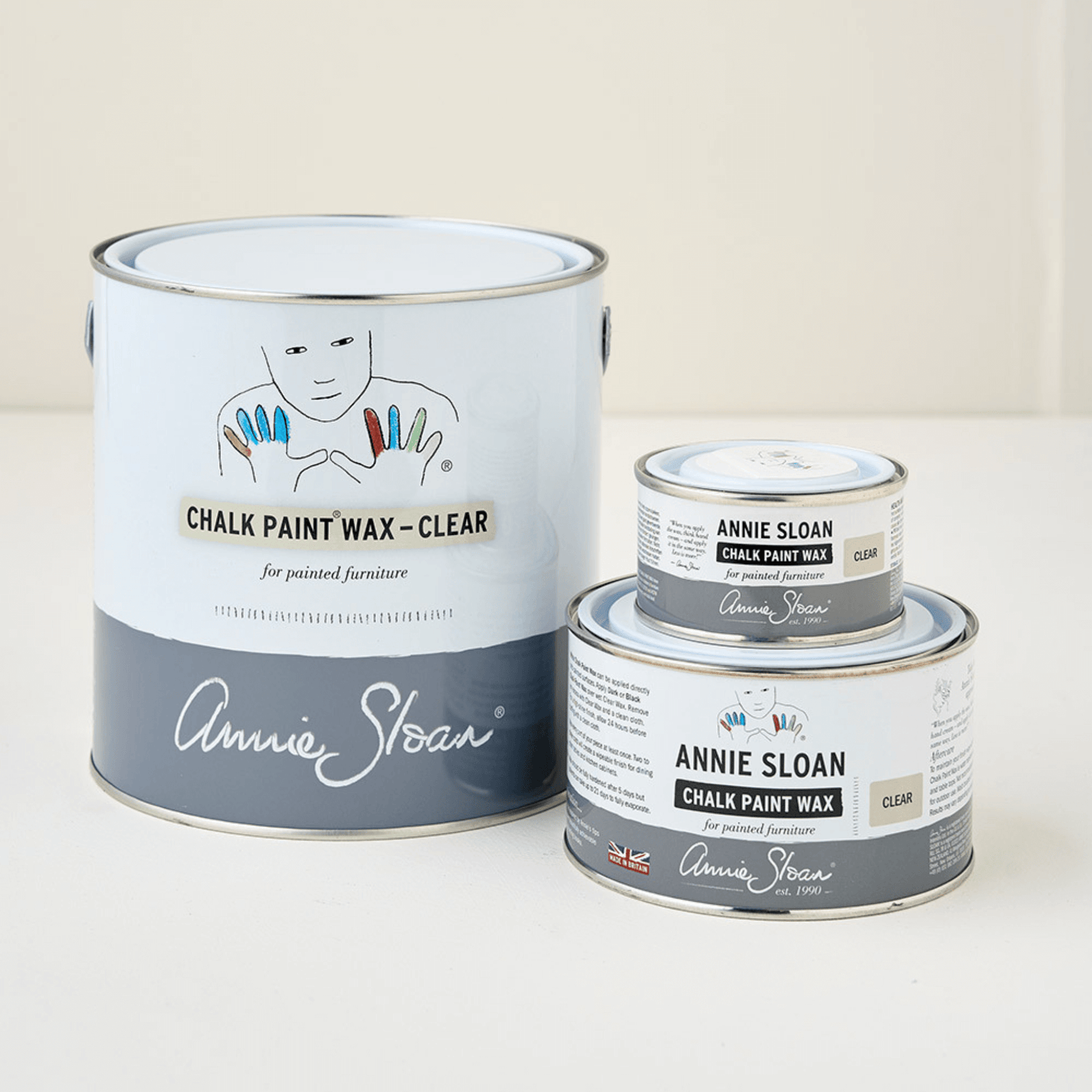 Three cans of Annie Sloan Chalk Paint Wax on a white background