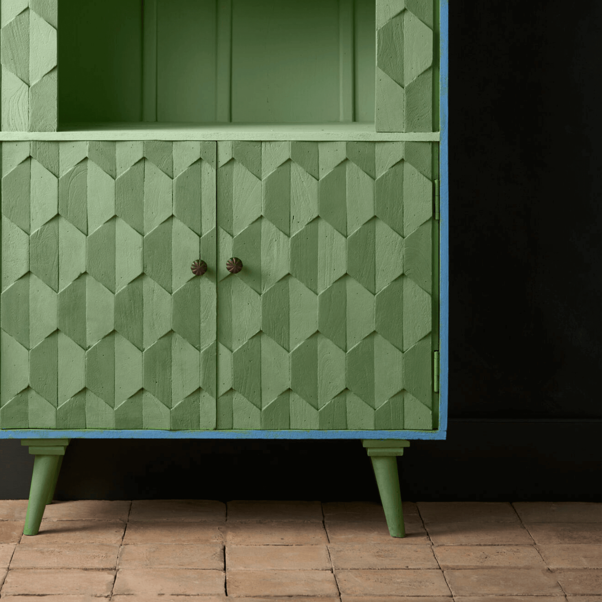 Capability Green Annie Sloan Chalk Paint used on a textured green cabinet with blue accents.