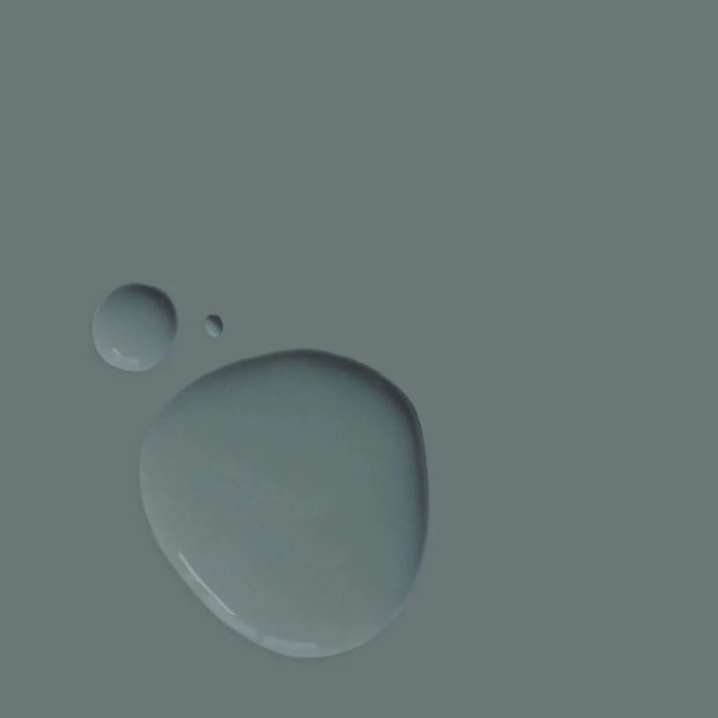 Cambrian Blue - Annie Sloan Satin Paint droplets on a textured surface showcasing its elegant denim color.