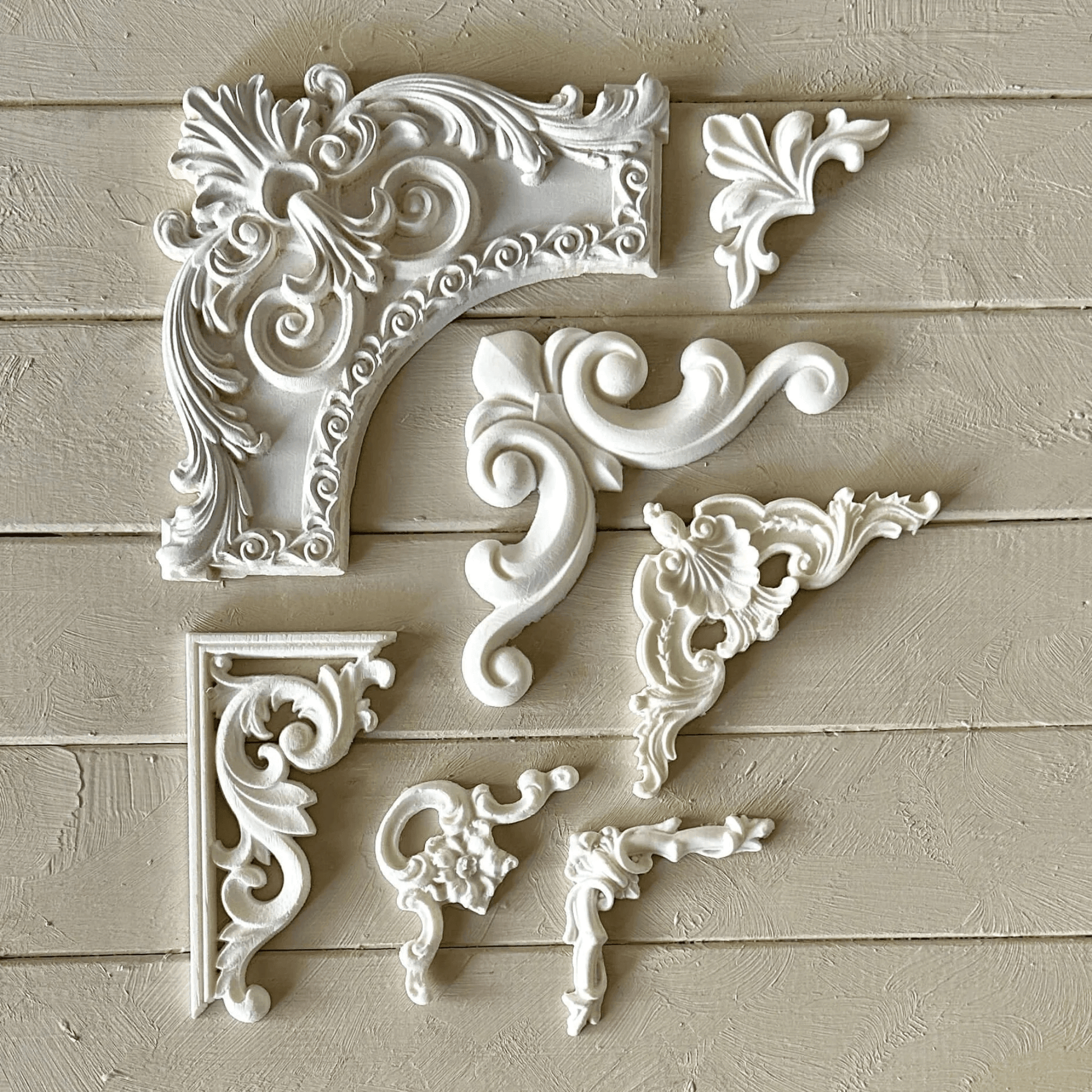 Collection of Elegant corner mouldings with classic raised detailed scrollwork, ideal for DIY furniture makeovers, textured paint effects, and vintage home styling.
