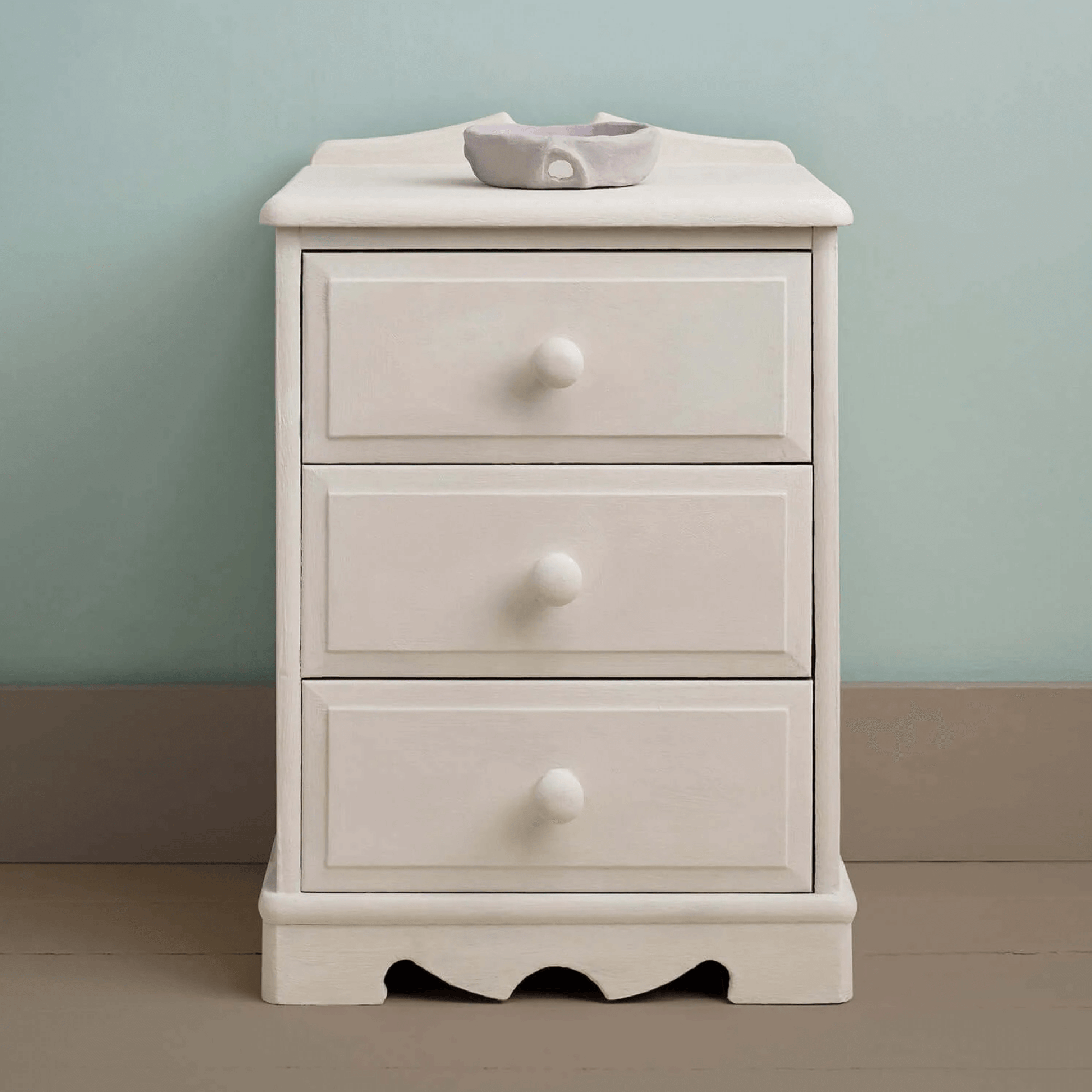 Furniture painted in Rococo White Chalk Paint by Annie Sloan, set against a soft blue wall.