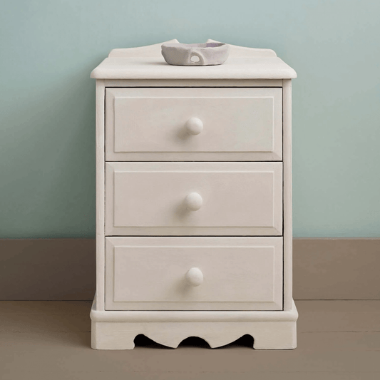 Furniture painted in Rococo White Chalk Paint by Annie Sloan, set against a soft blue wall.
