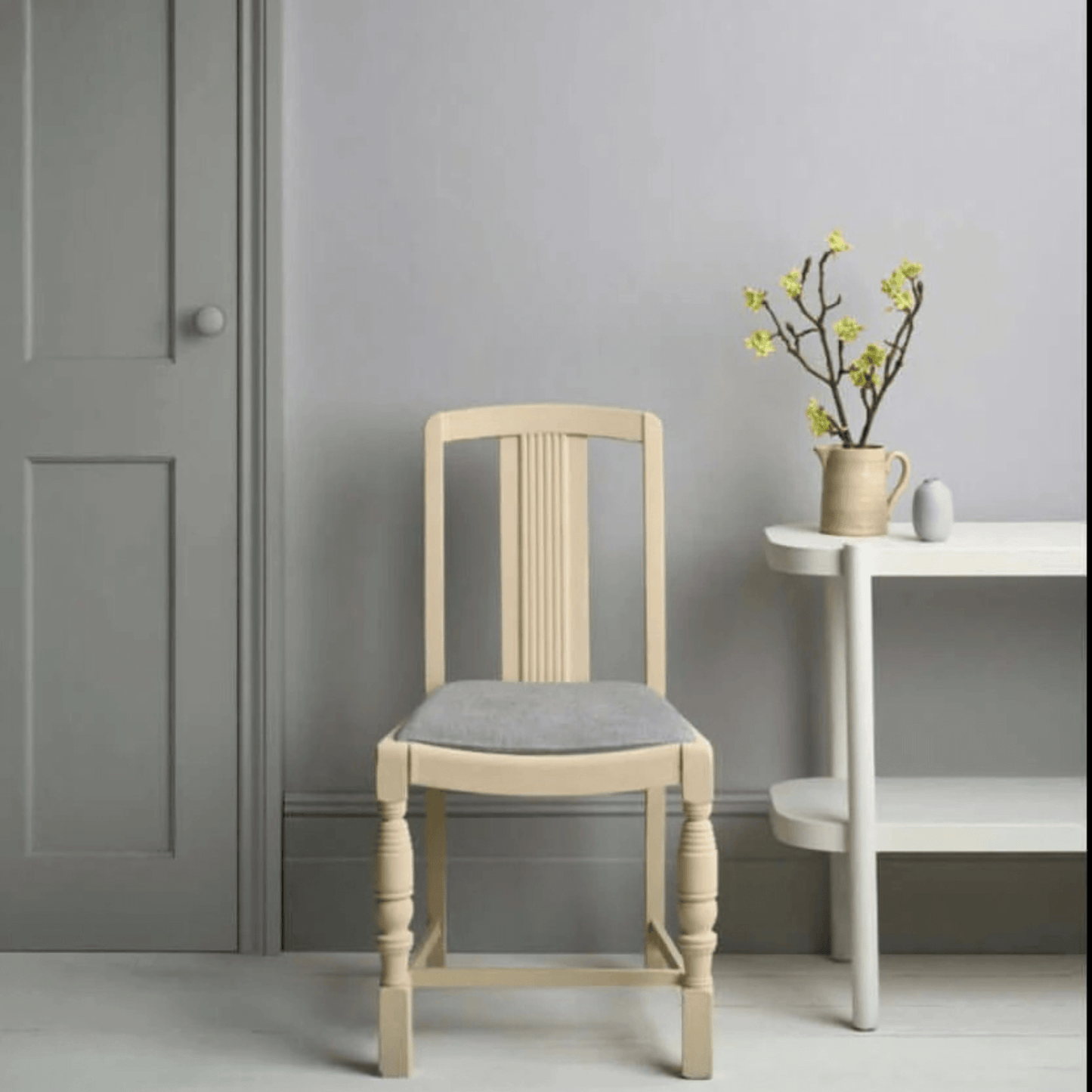 hicago Grey - Annie Sloan Satin Paint used on a modern chair and wall, showcasing clean lines in a stylish interior.