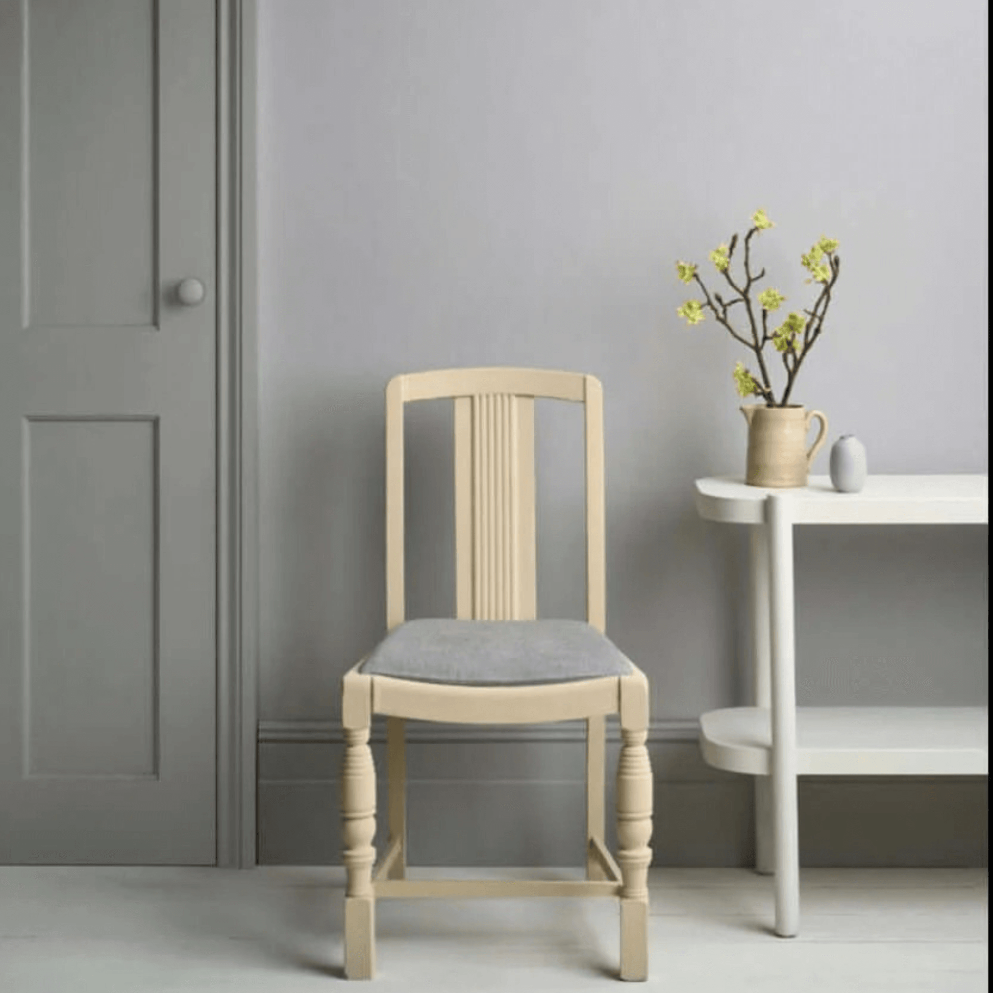 hicago Grey - Annie Sloan Satin Paint used on a modern chair and wall, showcasing clean lines in a stylish interior.