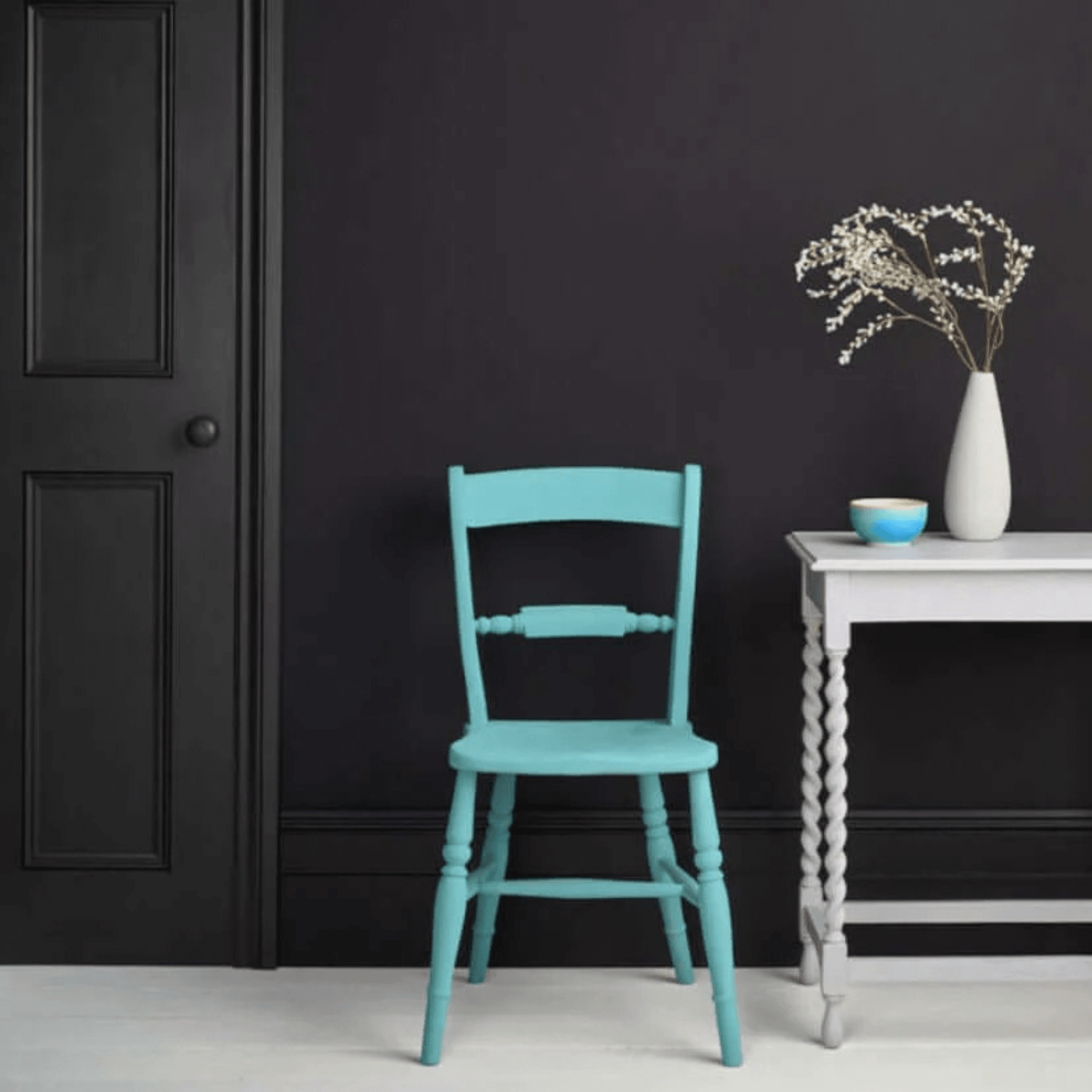 Athenian Black - Annie Sloan Satin Paint used on the wall behind a turquoise Provence Chalk Paint chair and Chicago Grey table.