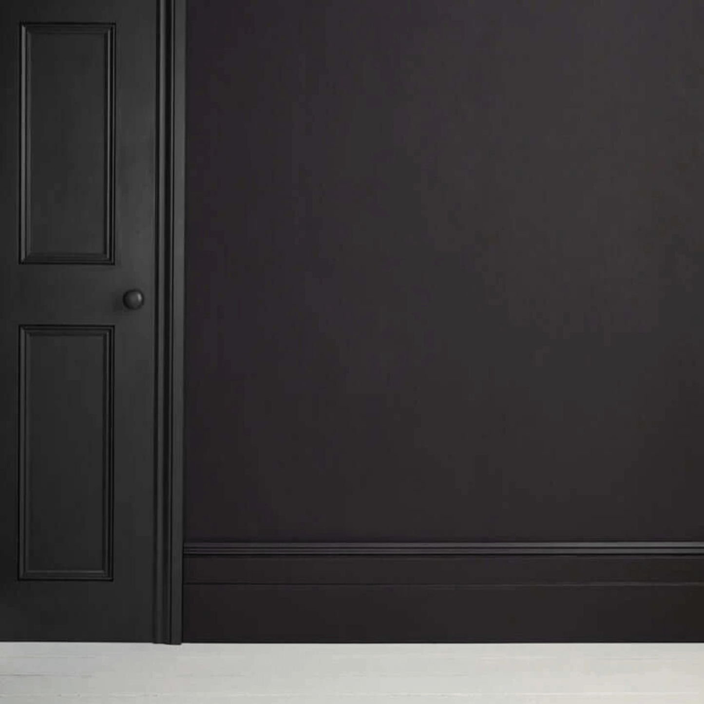 Athenian Black - Annie Sloan Satin Paint on a wall and door, showcasing a glossy pitch-black finish.
