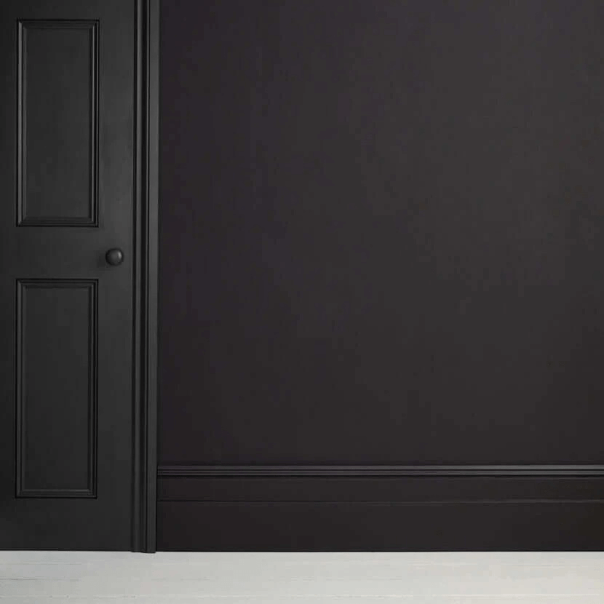 Athenian Black - Annie Sloan Satin Paint on a wall and door, showcasing a glossy pitch-black finish.