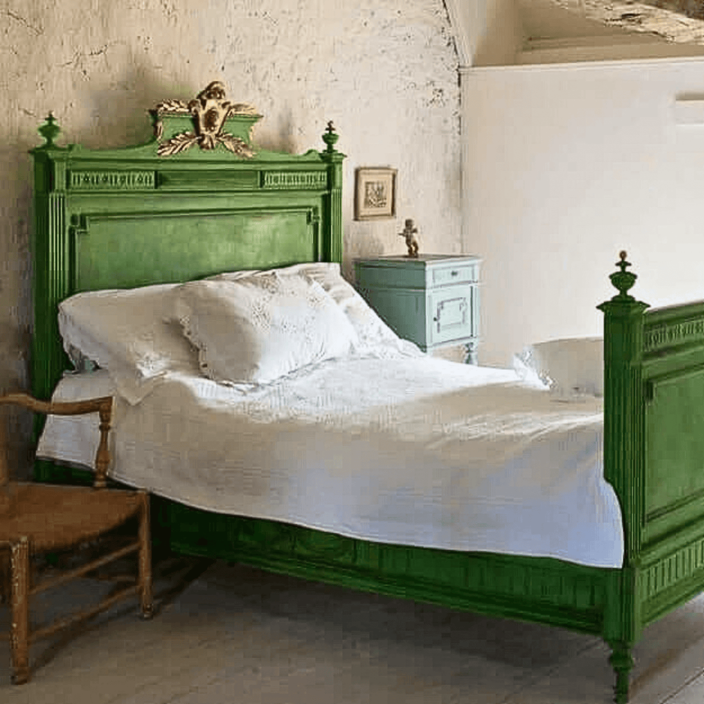 Antique wooden bed frame upcyled in Annie Sloan Antibes Green Chalk Paint and dark wax for a fresh country bedroom style.