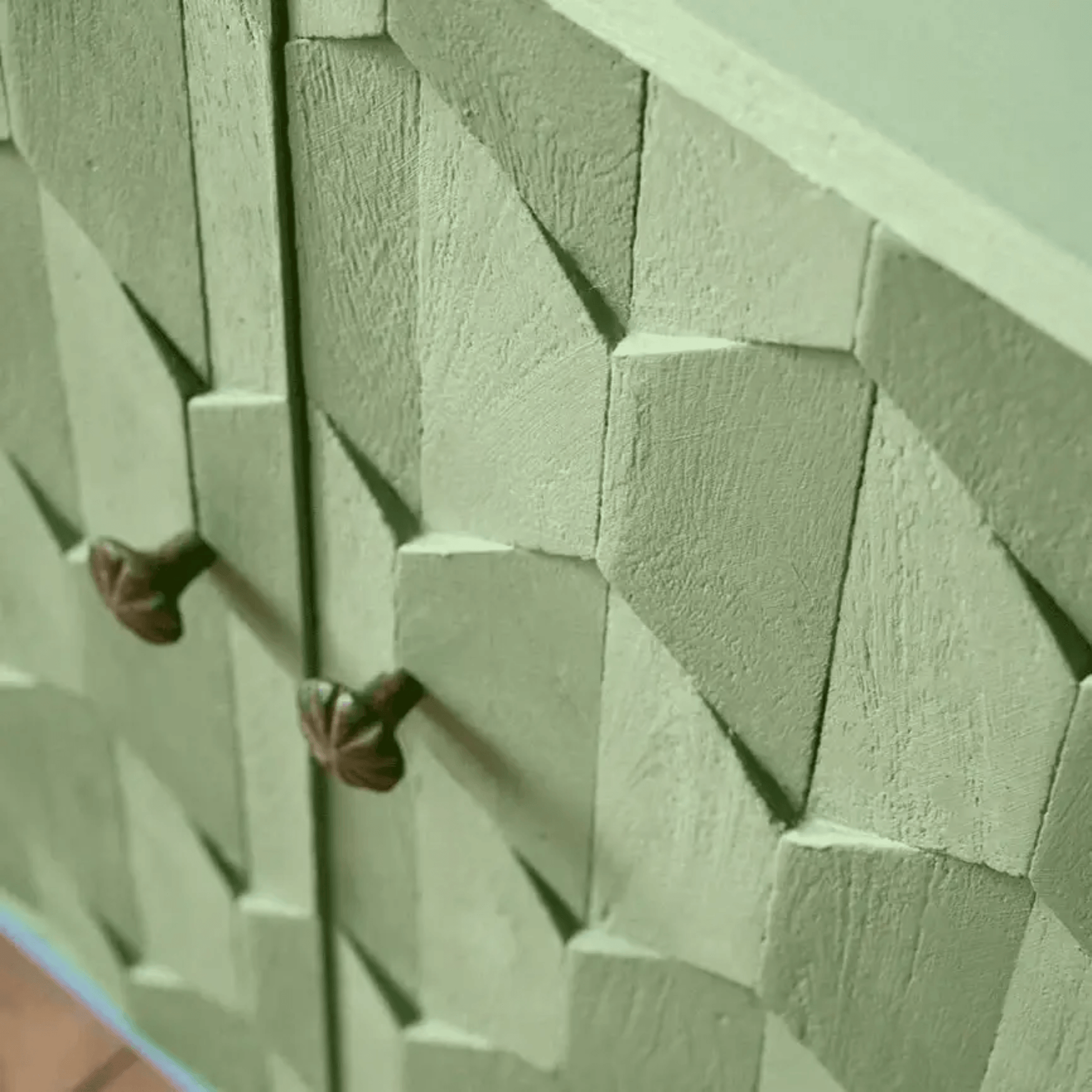 Capability Green Annie Sloan Chalk Paint® used on a textured cabinet with decorative knobs.