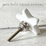 Rear view of a white ceramic star knob