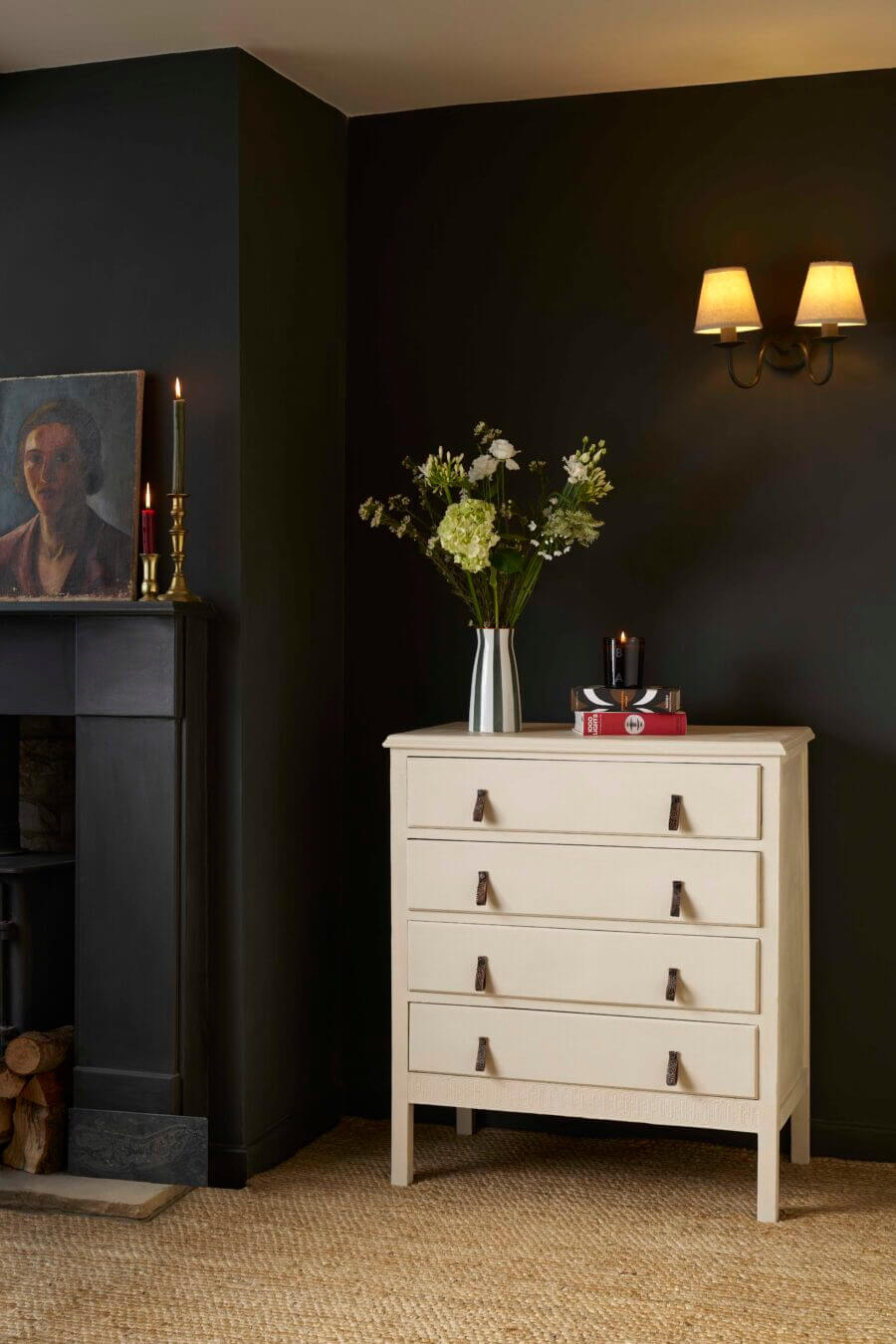 Dresser painted in Annie Sloan Canvas in a moody room with dark walls and floral styling.