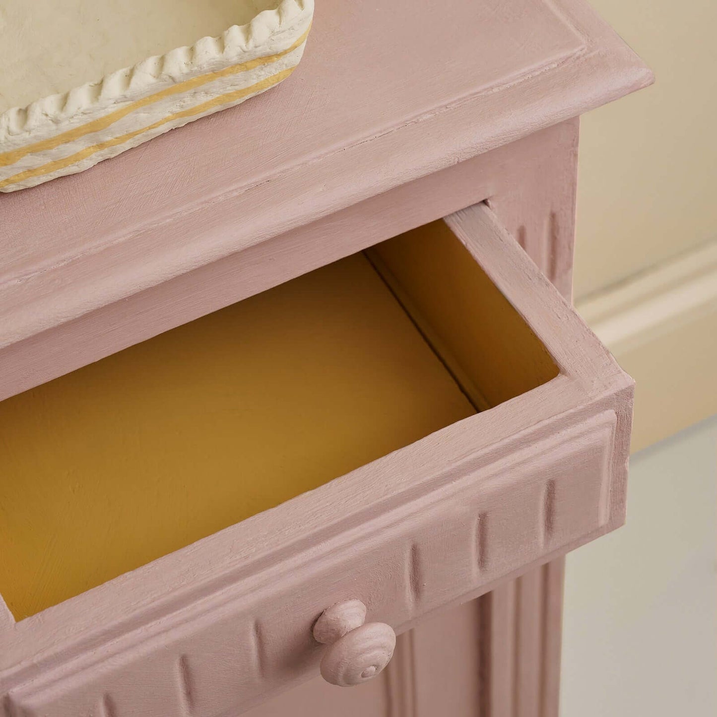 Open drawer of furniture painted with Jaipur Pink Annie Sloan Chalk Paint showcasing its warm tones.