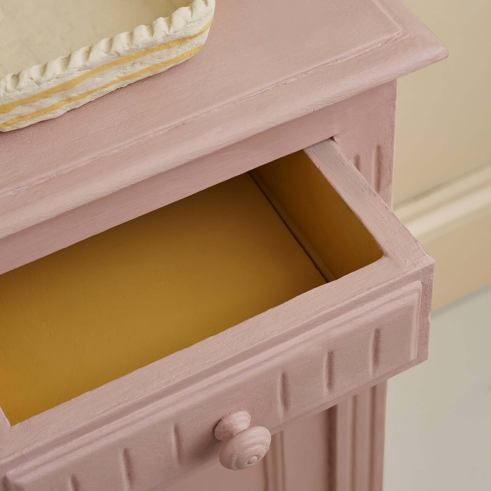Open drawer of furniture painted with Jaipur Pink Annie Sloan Chalk Paint showcasing its warm tones.