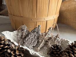 IOD Christmas Tapers Decor Mould displayed with pinecones and rustic decor in natural holiday setting.