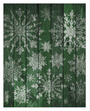 Stamped vintage snowflake designs in white on a green wooden background, showcasing the intricate detail and versatility of the IOD Vintage Snowflakes Stamp for holiday decor.