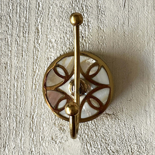 Mother of Pearl Wall Hook with shell inlay and brass accents on a textured background