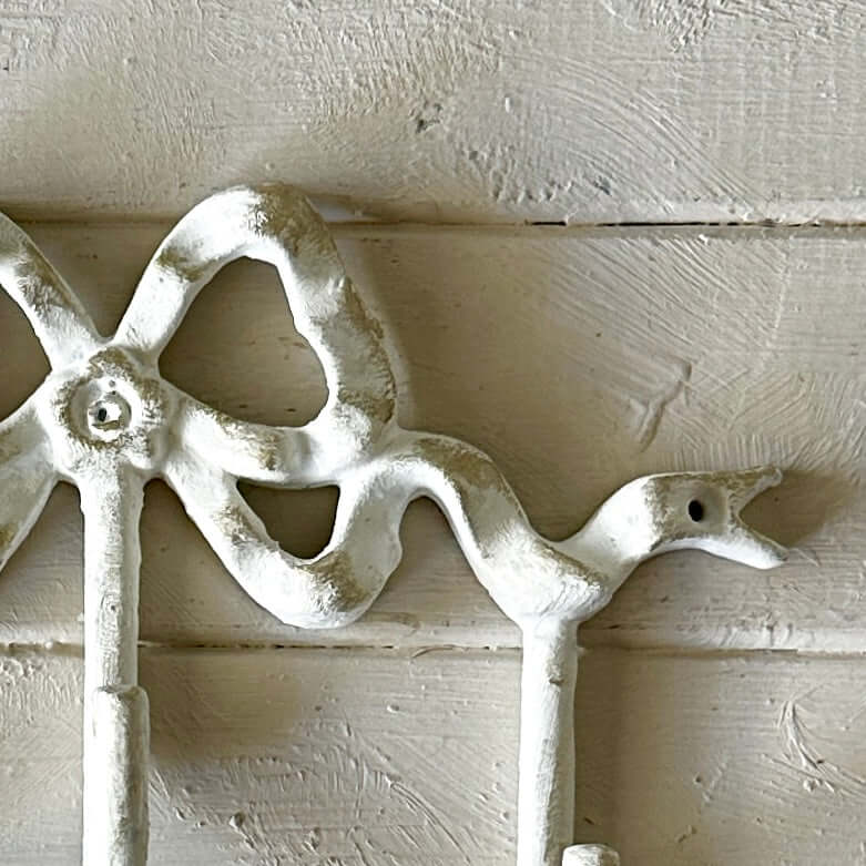 White Bow Wall Hook in vintage style with elegant curves, ideal for hanging accessories or as wall decor.