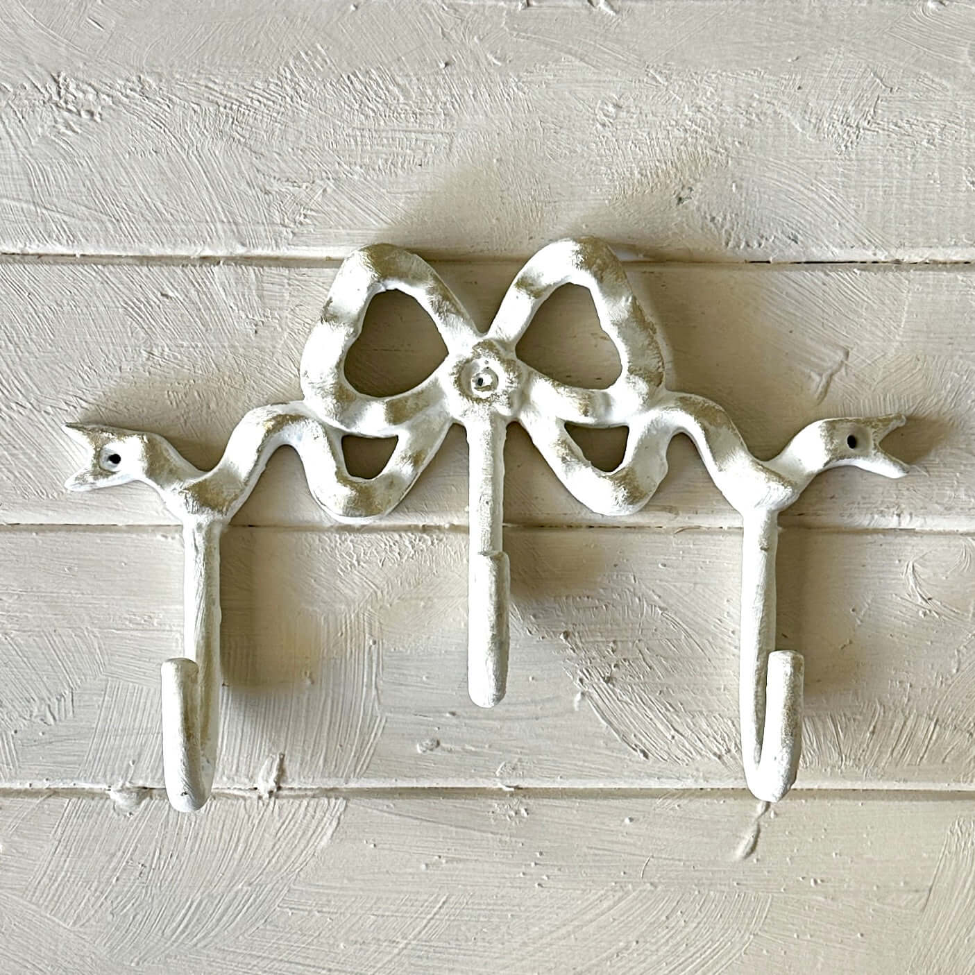 White Bow Wall Hook showcasing an elegant vintage design for hanging accessories on a decorative wall.