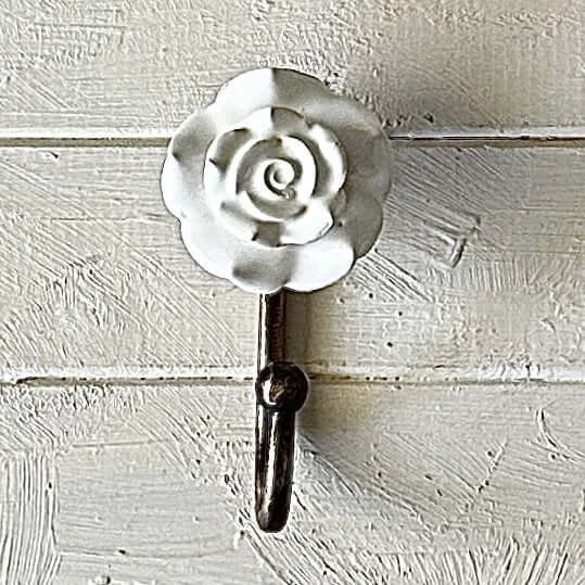 White Ceramic Rose Hook – Decorative wall hook featuring a ceramic rose and bronze hook for home organization.
