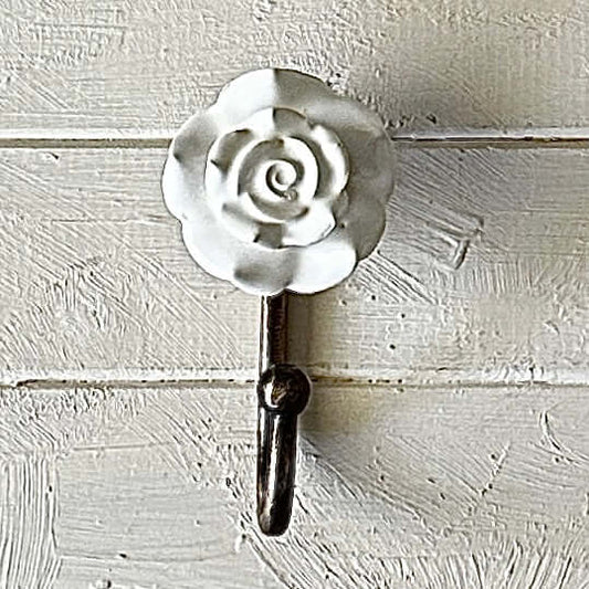 White Ceramic Rose Hook – Decorative wall hook featuring a ceramic rose and bronze hook for home organization.