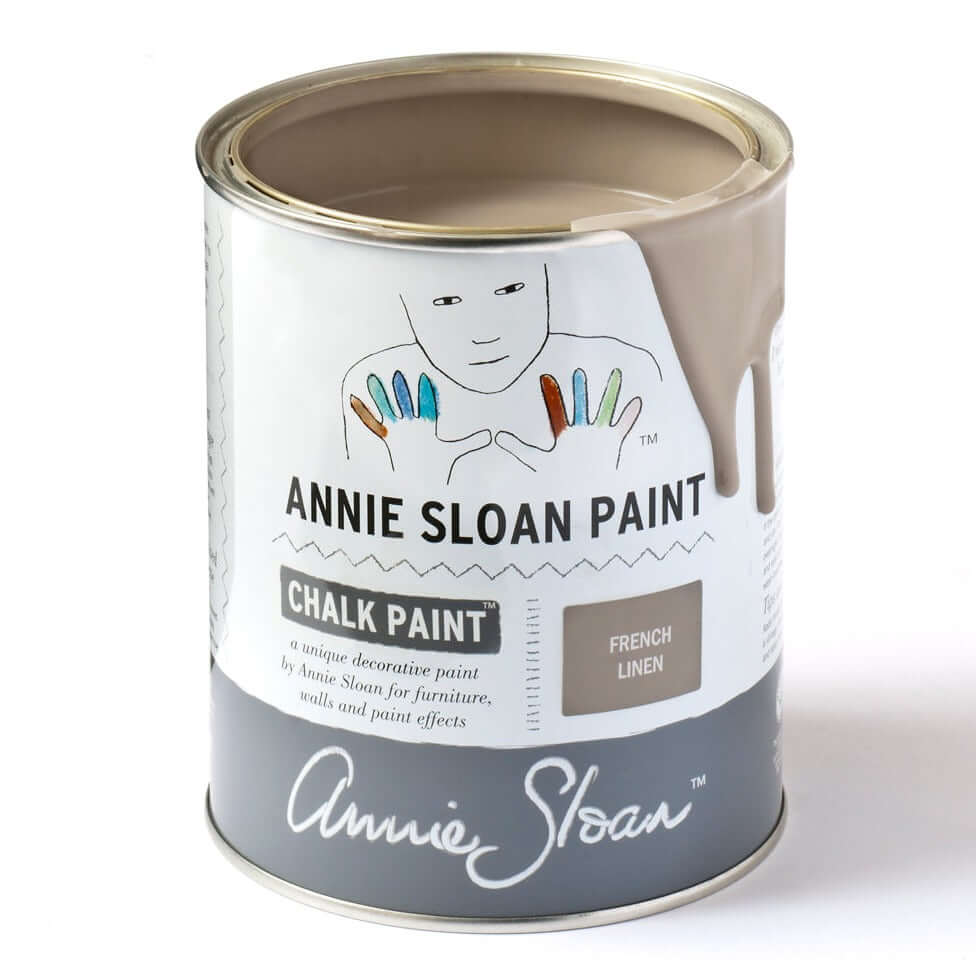 A can of Annie Sloan Chalk Paint in French Linen color, with the brand logo and product information displayed on the label.
